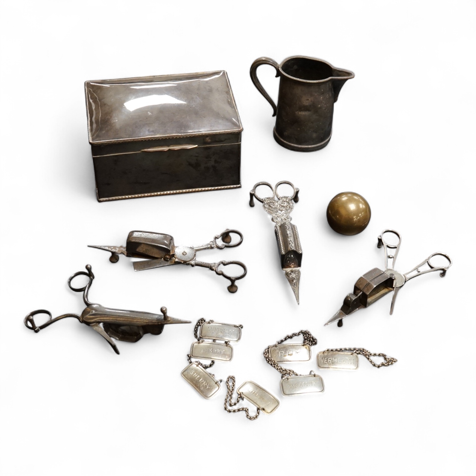 Four assorted pairs of 19th century plated candle snuffers, a large plated box, plated cream jug, ball and seven plated wine labels. Box 10cm high x 16.5cm wide.